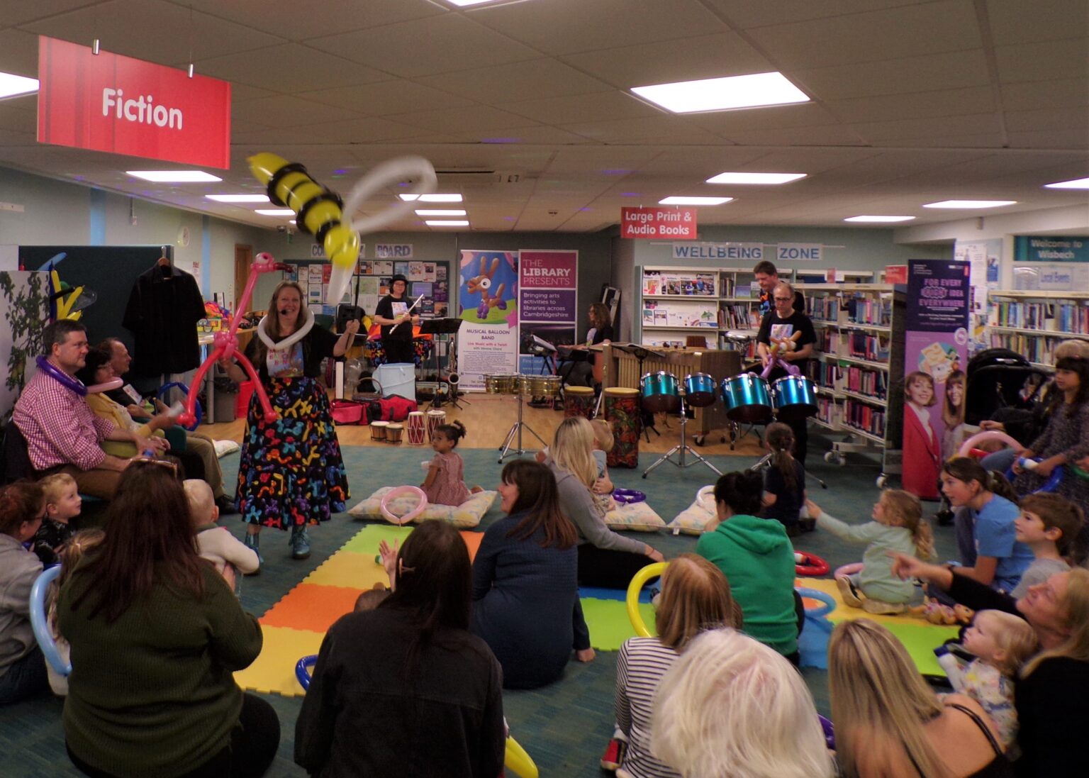 Audience at the Wisbech Library enjoying Betty Bee balloon in flight with the Musical Balloon Band's performance for 'The Library Presents'